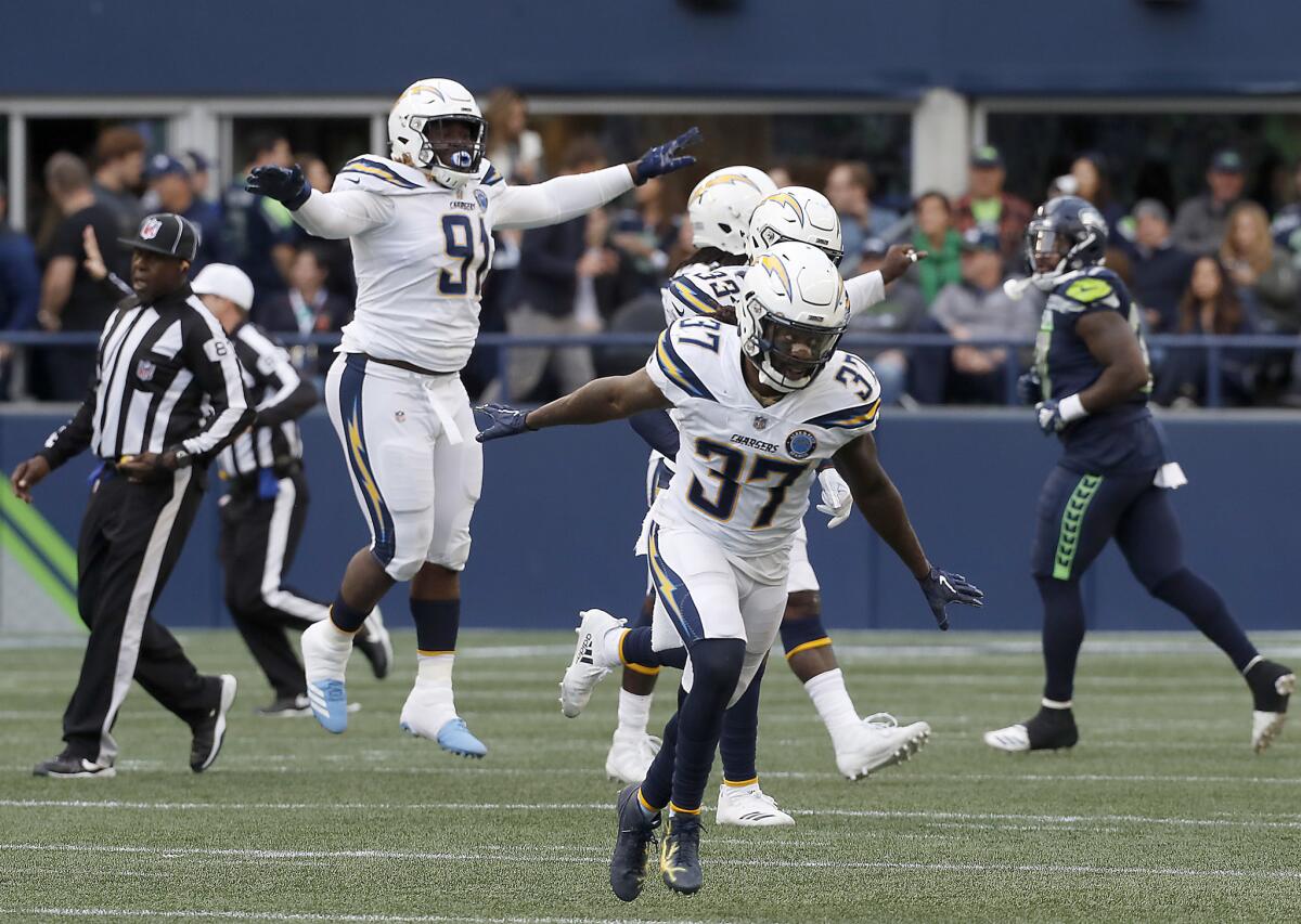 Safety Jaleel Addae and the Chargers defense celebrate after stopping a Seattle Seahawks drive in the fourth quarter Sunday at Century Link Field in Seattle.