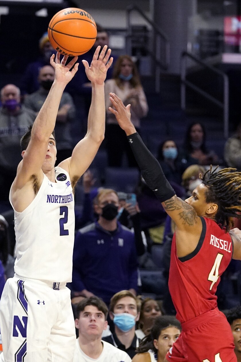 Northwestern guard Ryan Greer, left, shoots over Maryland guard Fatts Russell during the second overtime of an NCAA college basketball game in Evanston, Ill., Wednesday, Jan. 12, 2022. Maryland won 94-87 in the second overtime. (AP Photo/Nam Y. Huh)