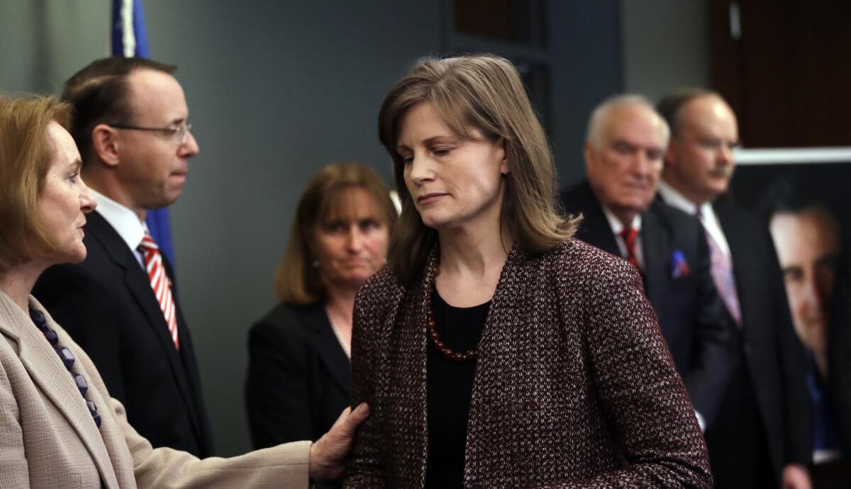 Seattle Mayor Jenny Durkan, left, greets Amy Wales after she urged the public to come forward with information into the unsolved 2001 slaying of her father, federal prosecutor Thomas C. Wales.