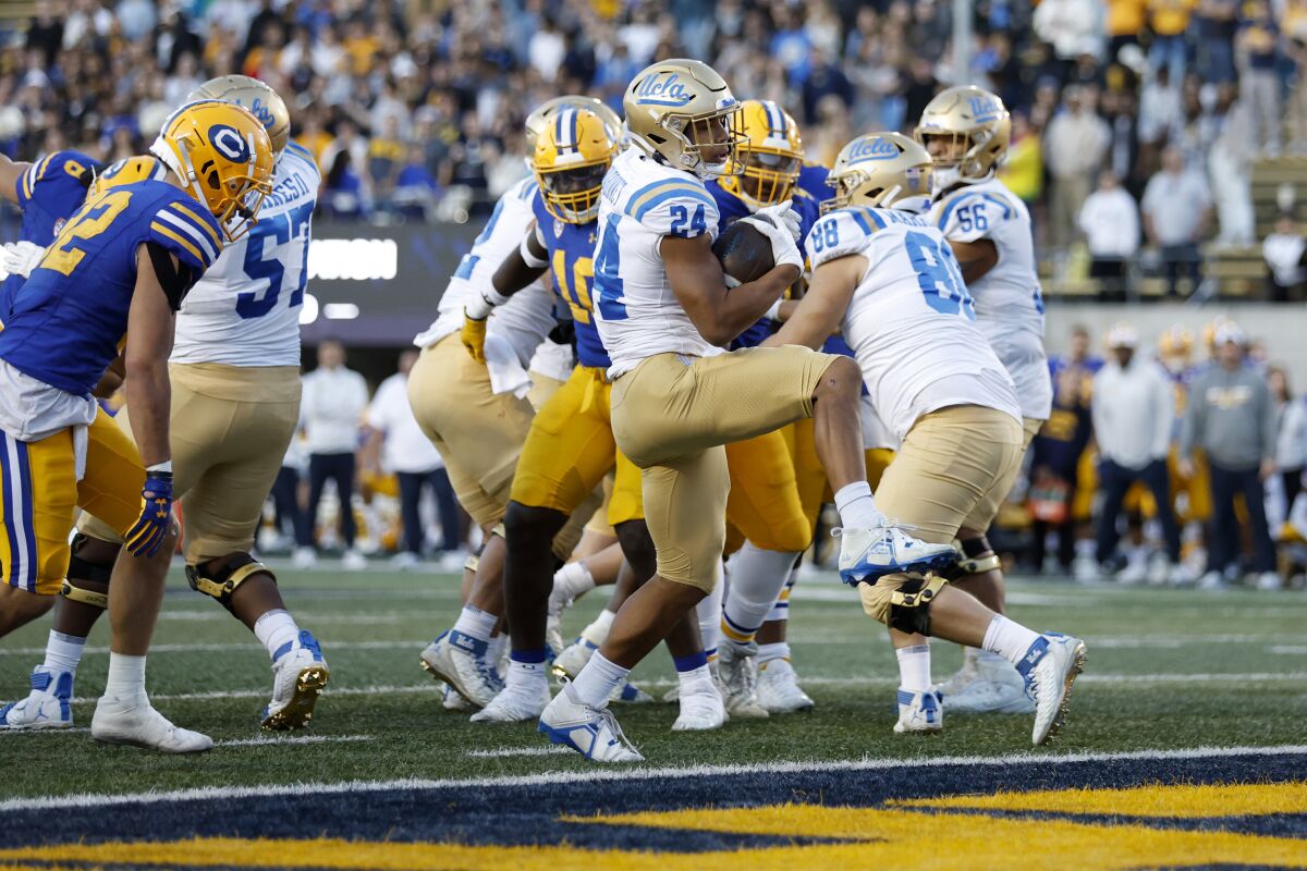 UCLA running back Zach Charbonnet scores a touchdown during the second half Nov. 25, 2022.
