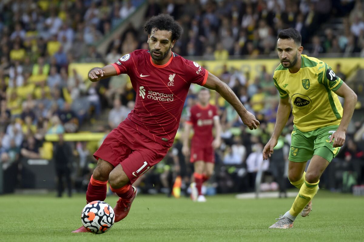 FILE - In this Aug. 14, 2021 file photo, Liverpool's Mohamed Salah runs with the ball during the English Premier League soccer match against Norwich City at Carrow Road Stadium in Norwich, England. Egypt's soccer association on Saturday, Sept. 4, says Salah has arrived in Gabon to join the Pharaohs for their World Cup qualifying match. (AP photo/Rui Vieira, File)