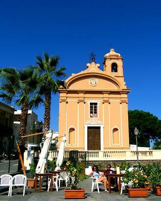 The church on the main piazza in Malfa, Salina's biggest town, serves as a backdrop for a sunny cafe. Read more: North of Sicily, Salina erupts with calm beauty