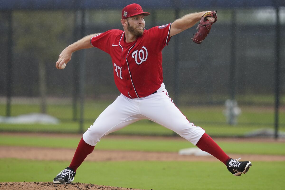Washington Nationals pitcher Stephen Strasburg throws live batting practice in a drizzle during the team's spring training baseball workout, Tuesday, March 15, 2022, in West Palm Beach, Fla. (AP Photo/Sue Ogrocki)