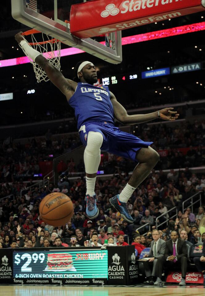 Montrezl Harrell finishes a breakaway dunk during the second half of a game against the Timberwolves on Feb. 1 at Staples Center.