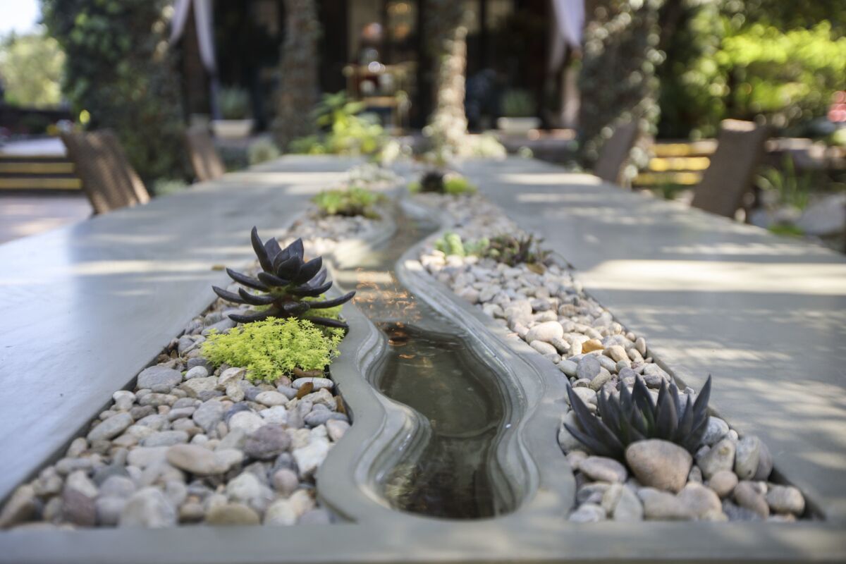 The concrete water table, the centerpiece of the Pool Garden by Pacific Outdoor Living, after renovations. (Patrick T. Fallon / For The Times)