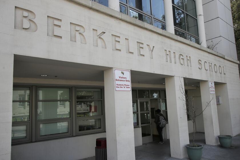 FILE - In this April 11, 2019, file photo, a student walks into Berkeley High School in Berkeley, Calif. California Democratic Gov. Gavin Newsom presented a revised $203 billion budget proposal to state lawmakers Thursday, May 14, 2020, reflecting an economy and tax revenues hobbled by the coronavirus pandemic. (AP Photo/Jeff Chiu, File)