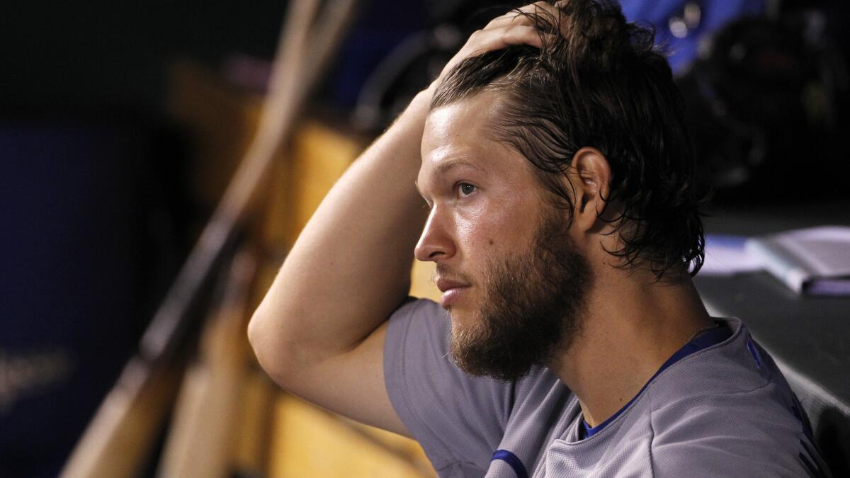 Dodgers pitcher Clayton Kershaw watches from the dugout at the end of the eighth inning during the team's 2-0 victory over the Kansas City Royals on Tuesday.