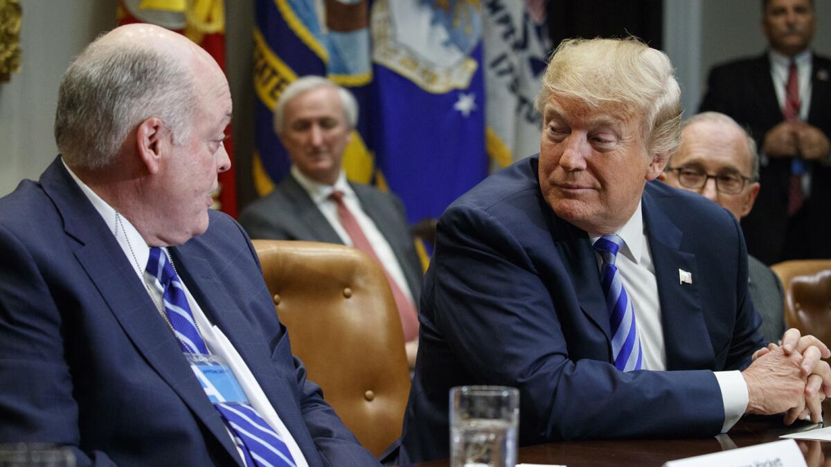 Ford CEO James Hackett talks to President Trump during Friday's meeting at the White House.