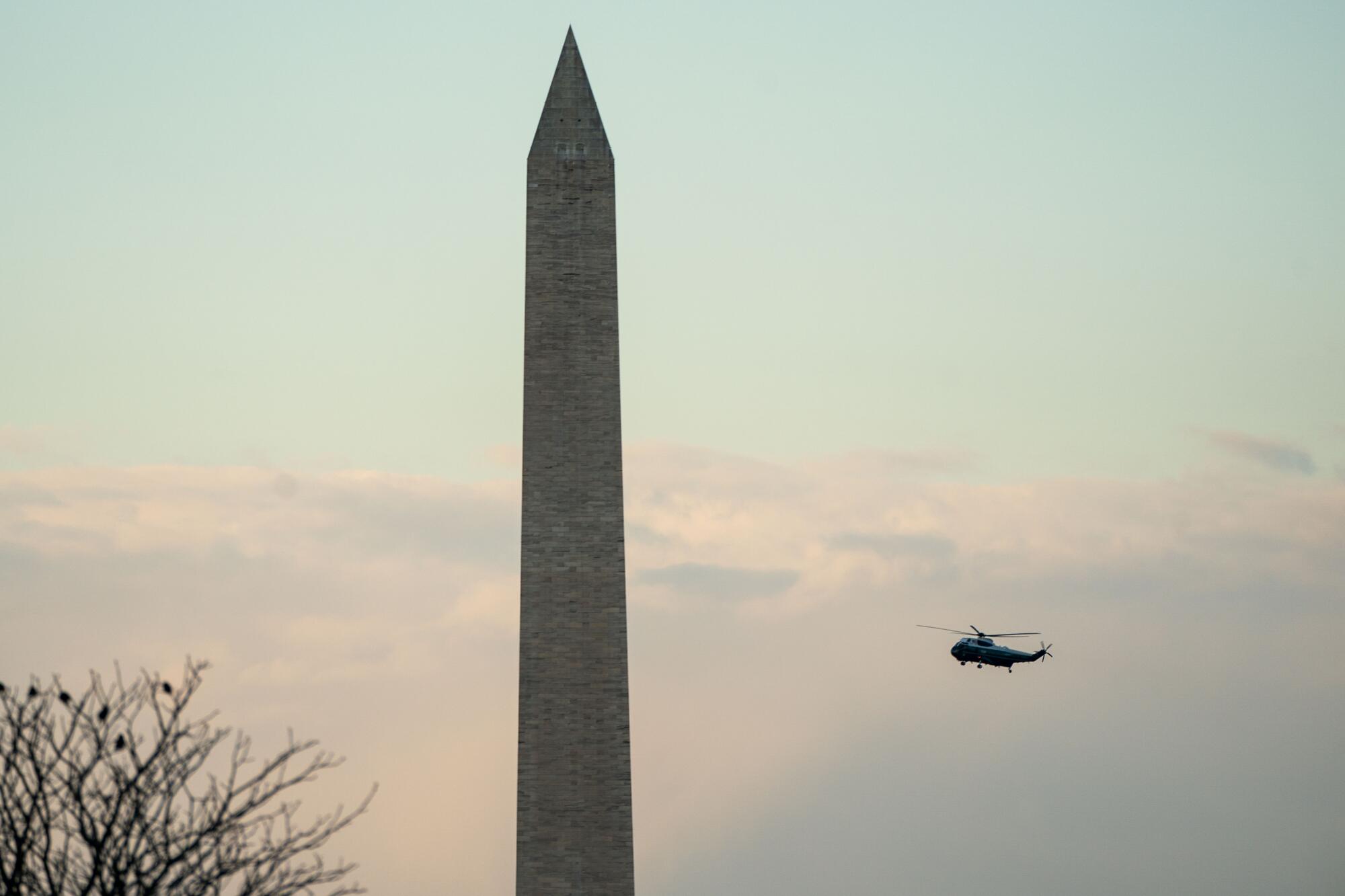 Marine One with President Trump and First Lady Melania Trump aboard flies past the Washington Monument.