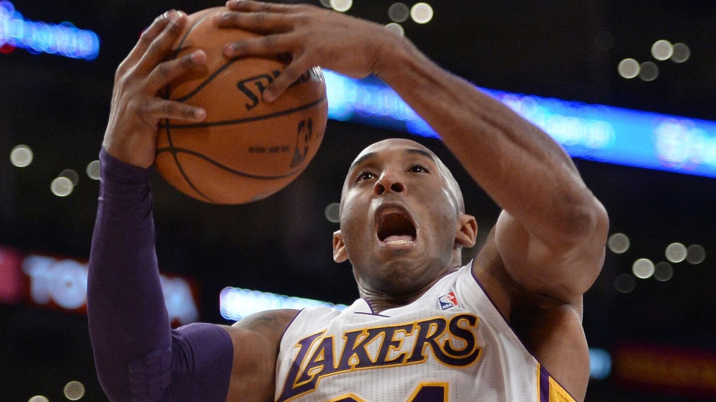 Lakers guard Kobe Bryant grabs a rebound against the Toronto Raptors at Staples Center on Dec. 8, 2013.
