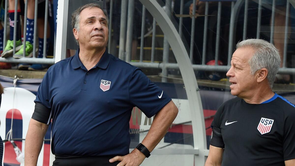 U.S. men’s national soccer team coach Bruce Arena, left, and assistant coach Dave Sarachan watch team introductions before a July 1 game against Ghana in East Hartford, Conn.