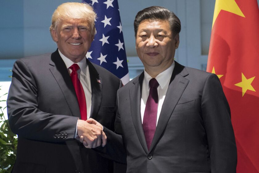 President Trump and Chinese President Xi Jinping shake hands as they arrive for a meeting on the sidelines of the G-20 Summit in Hamburg, Germany, Saturday, July 8, 2017.