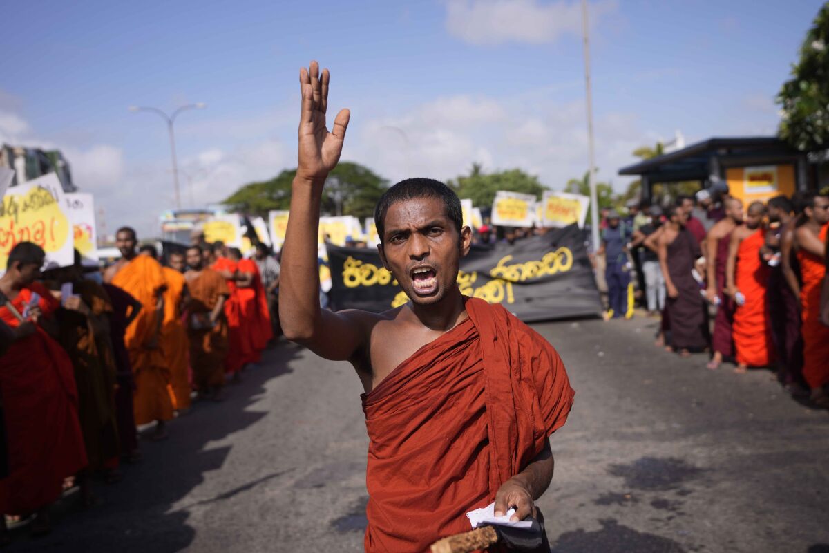 A student monk representing Inter University Students Federation shouts slogans during an anti government protest in Colombo, Sri Lanka, Thursday, May 19, 2022. Sri Lankans have been protesting for more than a month demanding the resignation of President Gotabaya Rajapaksa, holding him responsible for the country's worst economic crisis in recent memory. (AP Photo/Eranga Jayawardena)