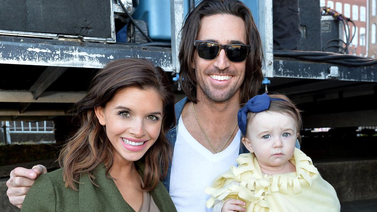 Lacey Buchanan and Jake Owen, shown with daughter Pearl at a Nashville event in 2013, are getting a divorce.