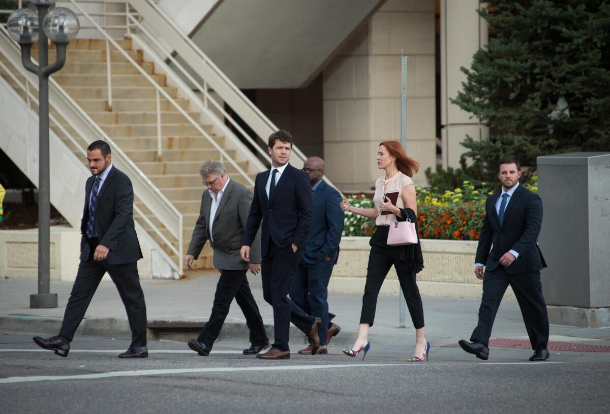 Taylor Swift's brother Austin, center, and her publicist, Tree Paine, second from right, walk to the Alfred A. Arraj Courthouse in Denver on Monday.