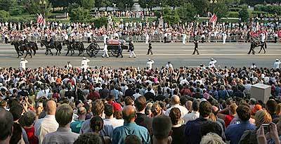 Following a long tradition, the body of former President Ronald Reagan, who was an avid horseman, is carried on a horse-drawn caisson Wednesday. Thousands of people lined Constitution Ave. in Washington, D.C. to witness the pageantry of the first U.S. presidential state funeral in three decades.