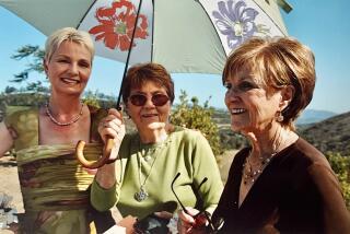 Three women under a parasol