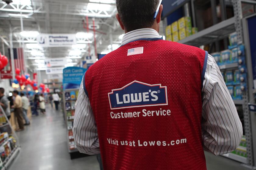 SAN FRANCISCO - NOVEMBER 04: A Lowe's employee walks through the store during the grand opening of the Lowe's store on November 4, 2010 in San Francisco, California. San Francisco mayor and California Lt. Governor-elect Gavin Newsom attended a ribbon cutting for the opening of a new Lowe's store in the city's Bayview district. (Photo by Justin Sullivan/Getty Images)