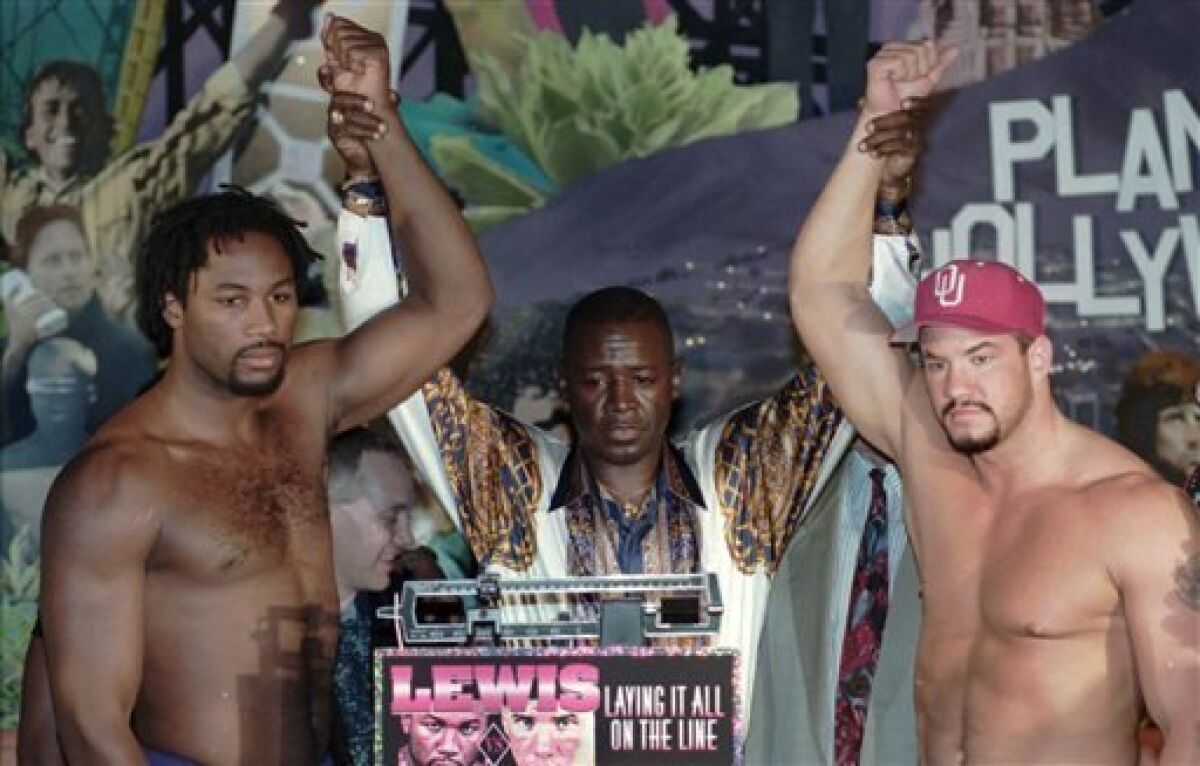 FILE - In this Oct. 6, 1995 file photo, New Jersey Boxing Commissioner Larry Hazzard Jr., center, poses Lennox Lewis, left, of London, England, and Tommy Morrison, of Southwest City, Okla., after their weigh-in at Planet Hollywood on the Boardwalk in Atlantic City, N.J. Morrison, the former heavyweight champ who stood toe-to-toe with Lennox Lewis and George Foreman and later tested positive for HIV, has died. He was 44. Morrison's former manager, Tony Holden says his longtime friend died Sunday