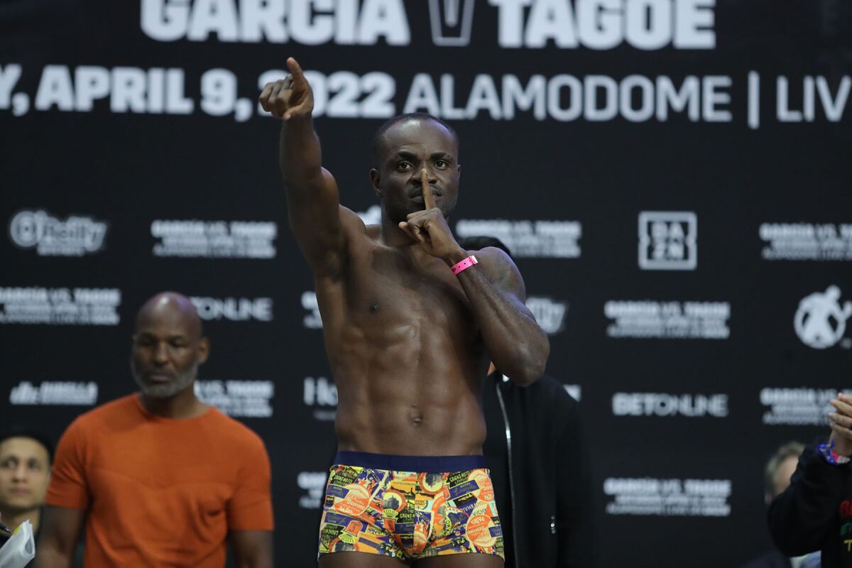 Emmanuel Tagoe point toward the crowd during his weigh-in.