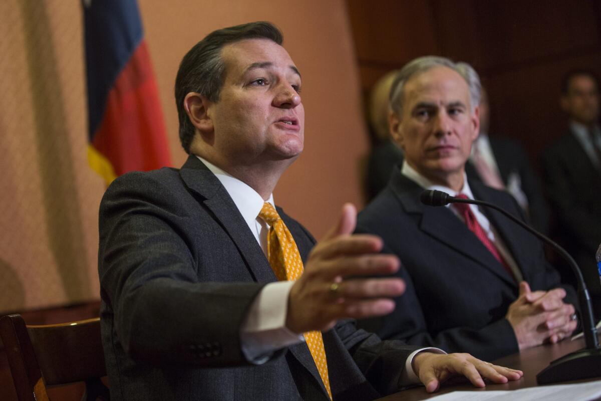 Republican Senator Ted Cruz discusses the Obama Administration's efforts to resettle Syrian refugees in the United States while Texas Governor Greg Abbott looks on in Washington, D.C. on Dec. 8.