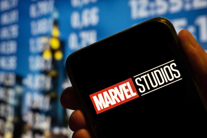 The Marvel Studios logo is displayed on a smartphone screen.