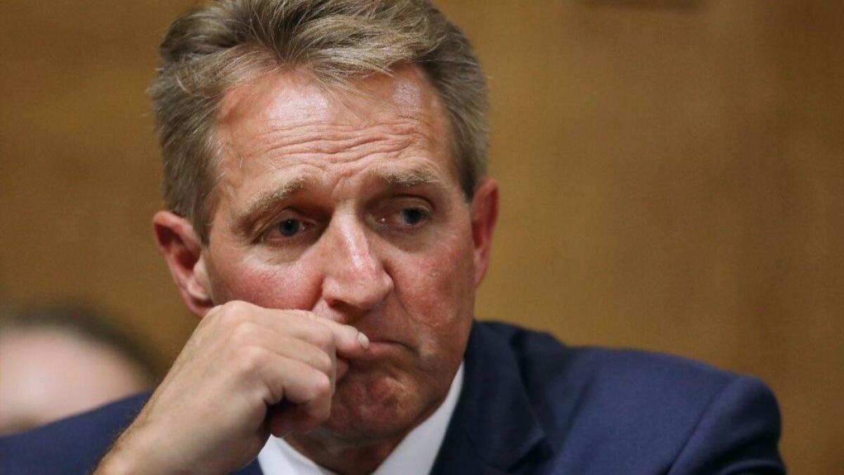 Sen Jeff Flake listens during a Senate Judiciary Committee hearing on Friday.