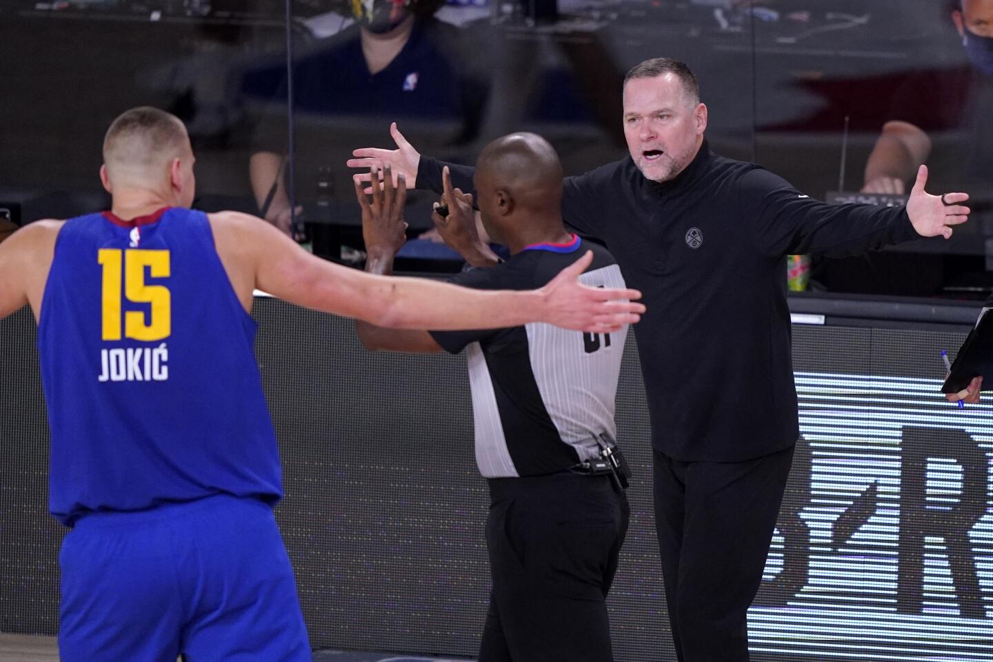Nuggets center Nikola Jokic and coach Michael Malone disagree with referee Courtney Kirkland during Game 1.