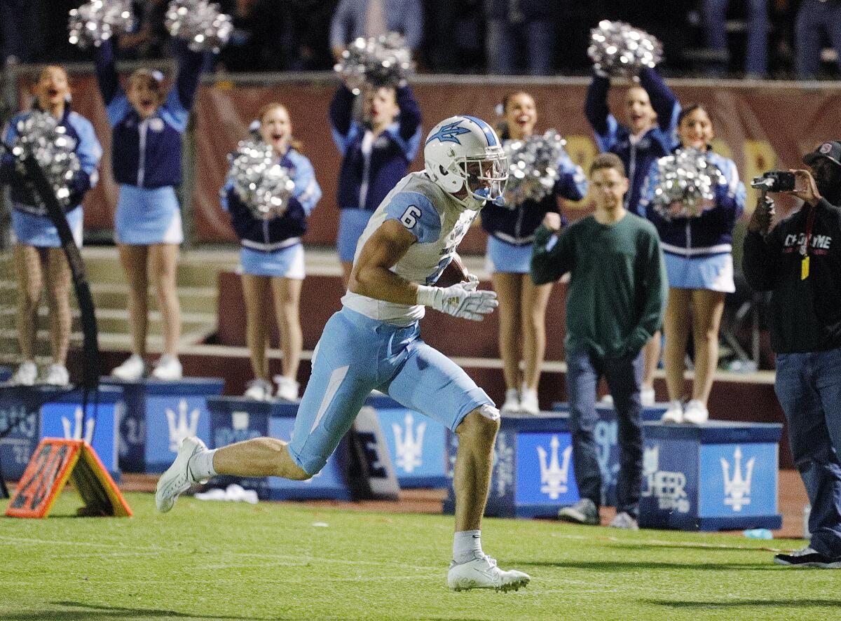 Corona del Mar's John Humphreys runs for the end zone to complete a 65-yard touchdown catch against Alemany in the fourth quarter of a CIF Southern Section Division 3 semifinal game in Mission Hills on Friday.