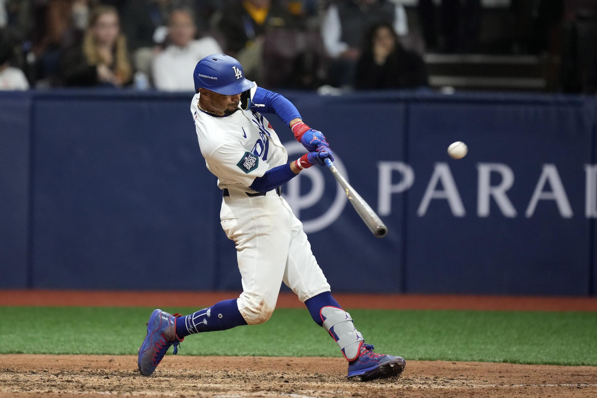 Los Angeles Dodgers' Mookie Betts hits a solo home run during the fifth inning of a baseball game.