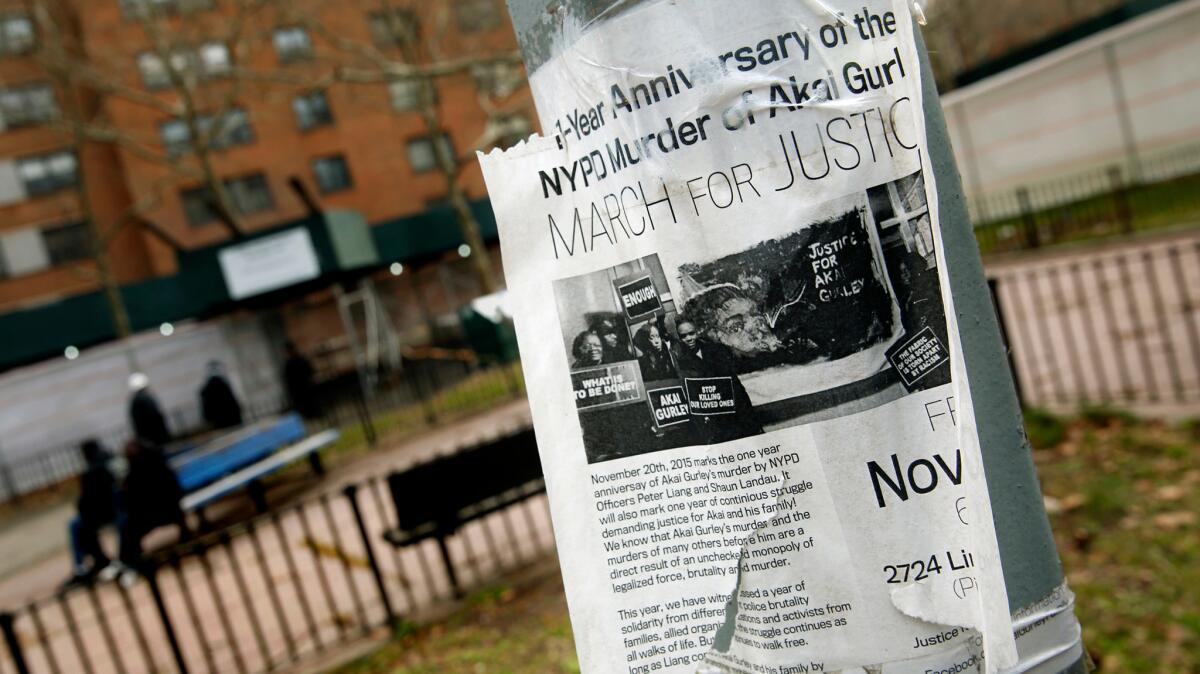 A poster in New York announces a protest march a year after the shooting death of Akai Gurley. (Carolyn Cole / Los Angeles Times)