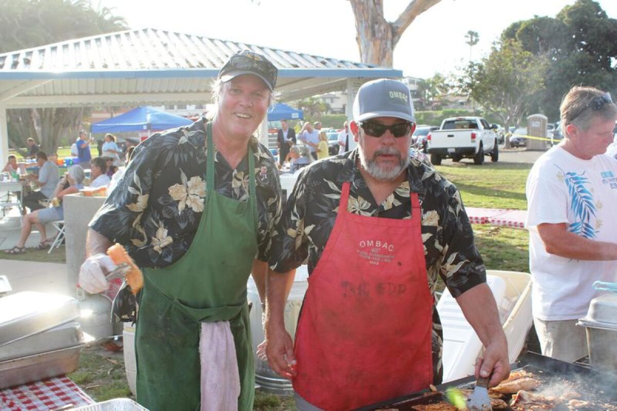 Old Mission Beach Athletic Club members Ross Hollin and Paul Willemssen man the grill.