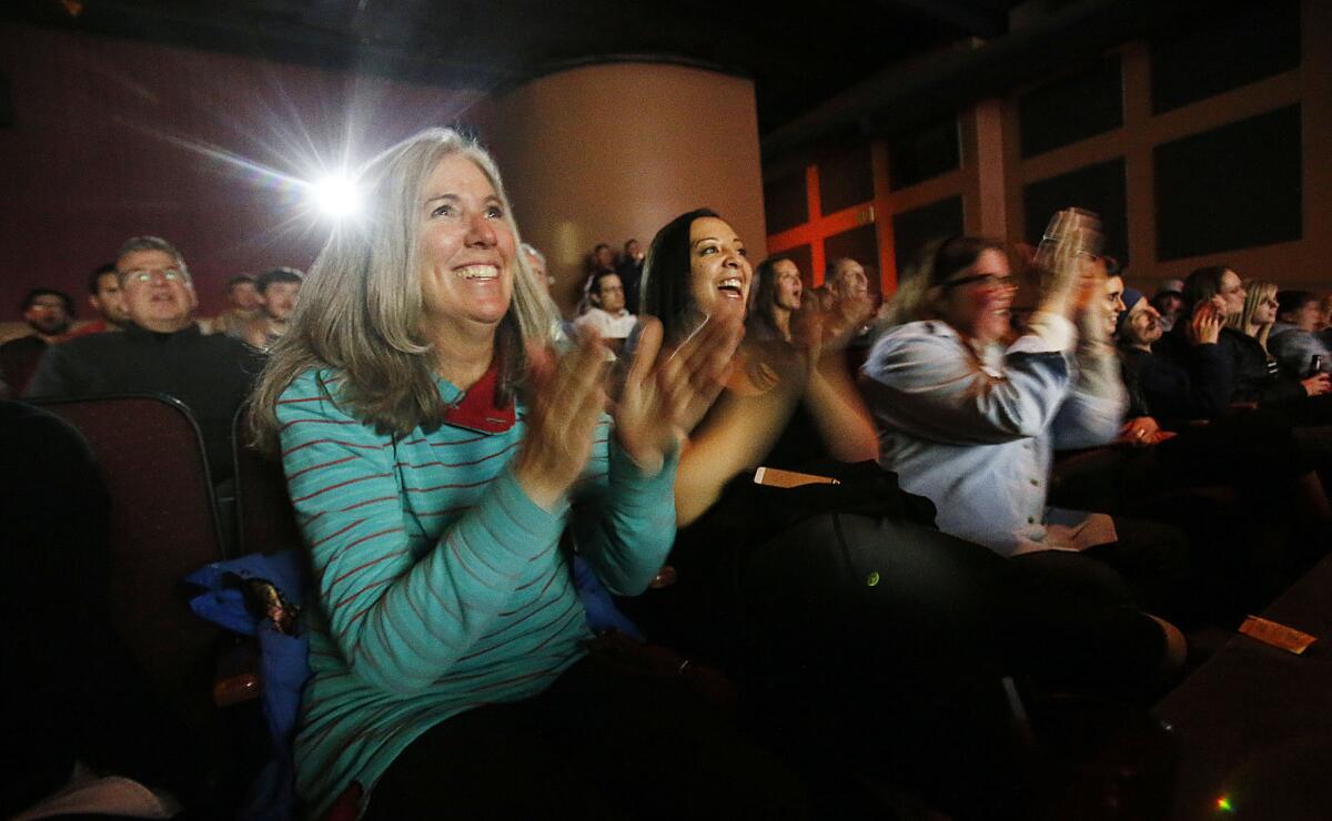 Carol Ann Kotsenburg, left, cheers as she watches her son Sage win the gold in snowboard slopestyle at the Winter Olympics in Sochi, Russia. Though Carol Ann and her husband, Stephen, had earlier watched the win live, they joined family and friends later on at Brewvies Cinema Pub in Salt Lake City, Utah, to watch the 20-year-old's performance.