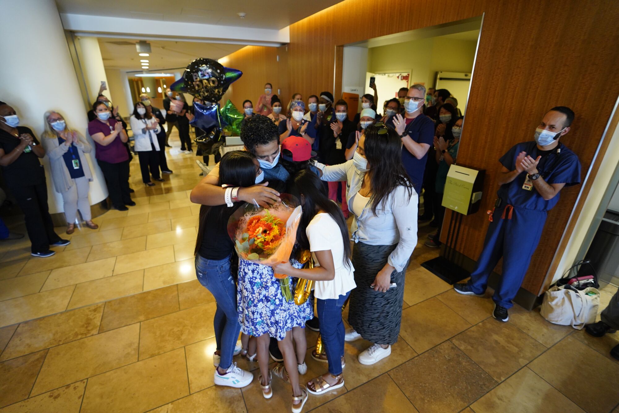 COVID-19 survivor Eli Centeno 37, greets his family as he's discharged from the hospital.