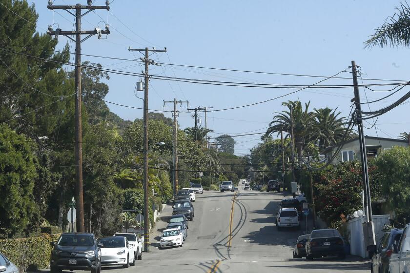 Power poles line Glenneyre St. in the underground utility district in the neighborhood of Woods Cove in Laguna Beach.