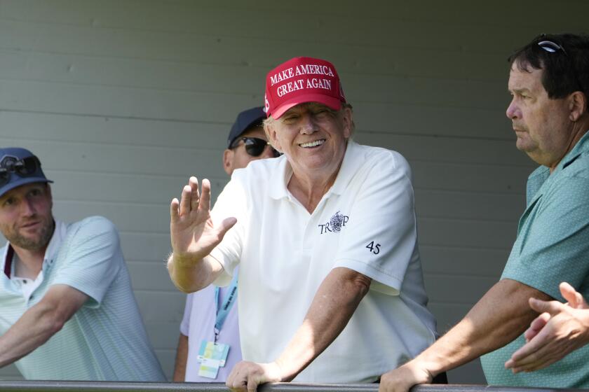 Former President Donald Trump waves at fans in the crowd, during the first round of the LIV Golf Tournament at Trump National Golf Club, Friday, May 26, 2023, in Sterling, Va. (AP Photo/Alex Brandon)