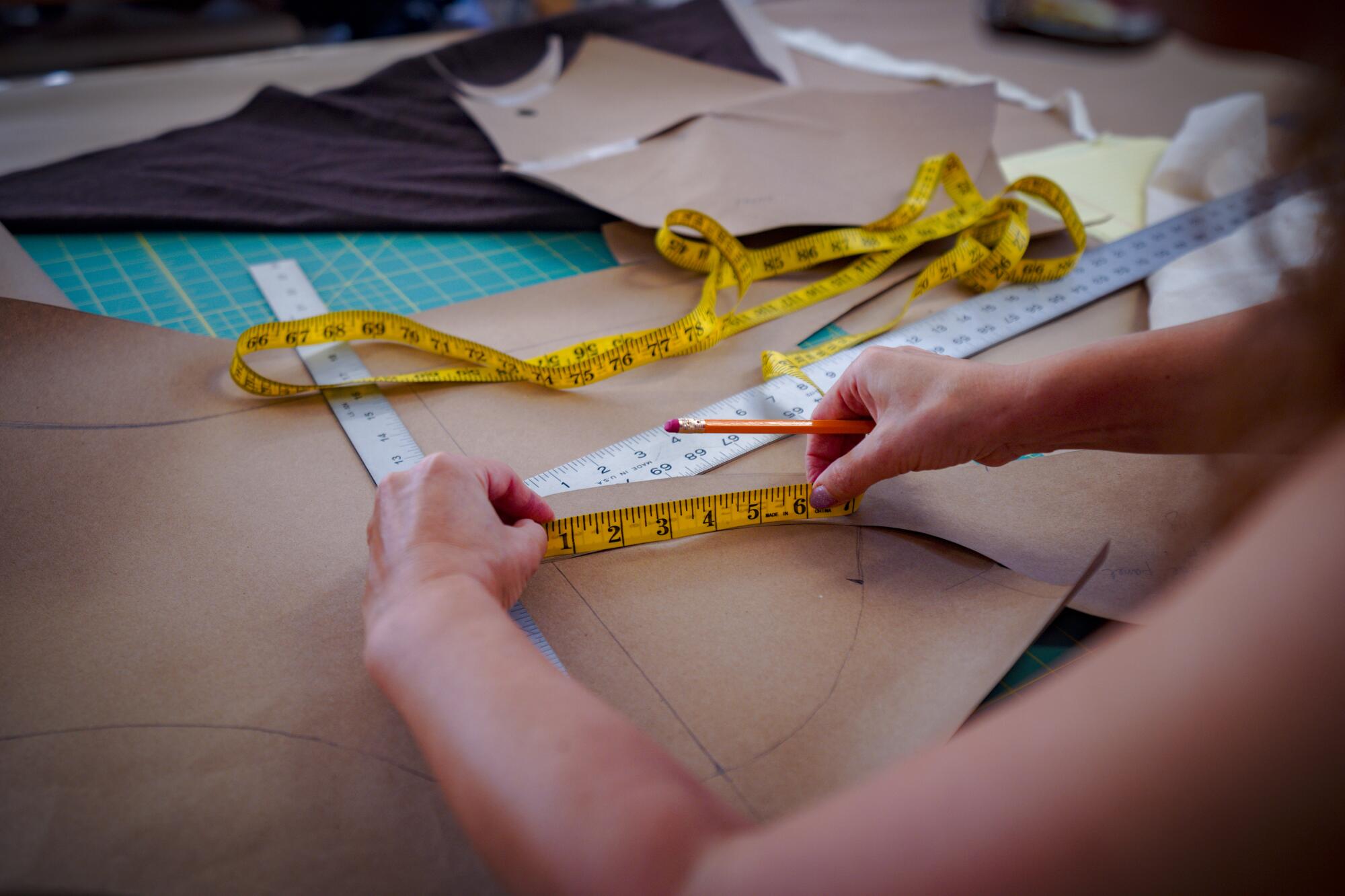 Anastasia Pautova, costume shop manager, creates an original sewing pattern for a costume.