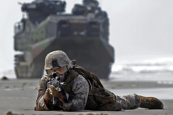 During a training exercise at Camp Pendleton, Pfc. Marc Calo holds his position on the sand after coming ashore on an assault vehicle. It was the largest and most complex amphibious exercise since the Sept. 11, 2001, attacks, but it also could be one of the last.