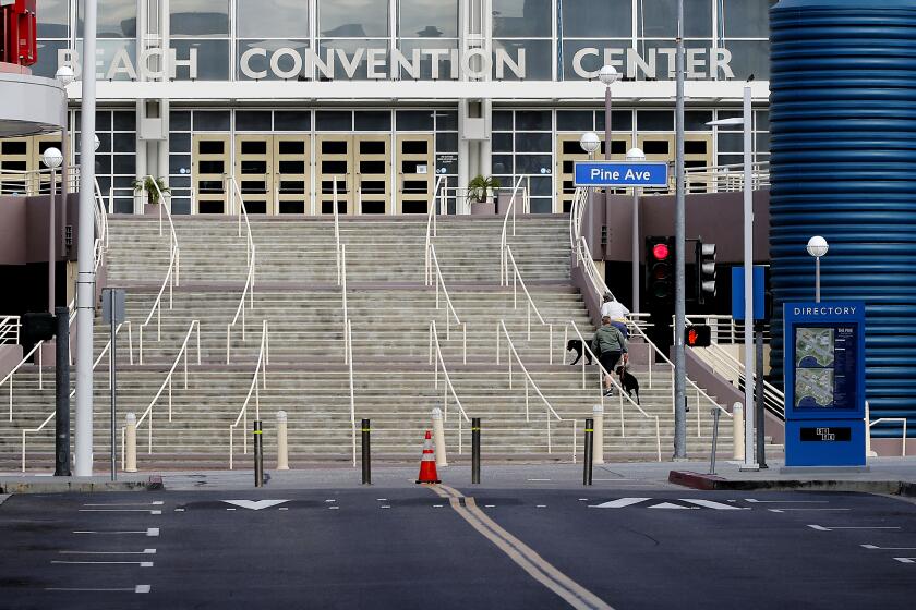 LONG BEACH, CALIF. -MAR. 25, 2020. The Pike in and convention center in Long Beach - normally crowded with shoppers, diners and conventioneers - is almost completely deserted because of the coronavirus lockdown. (Luis Sinco/Los Angeles Times)