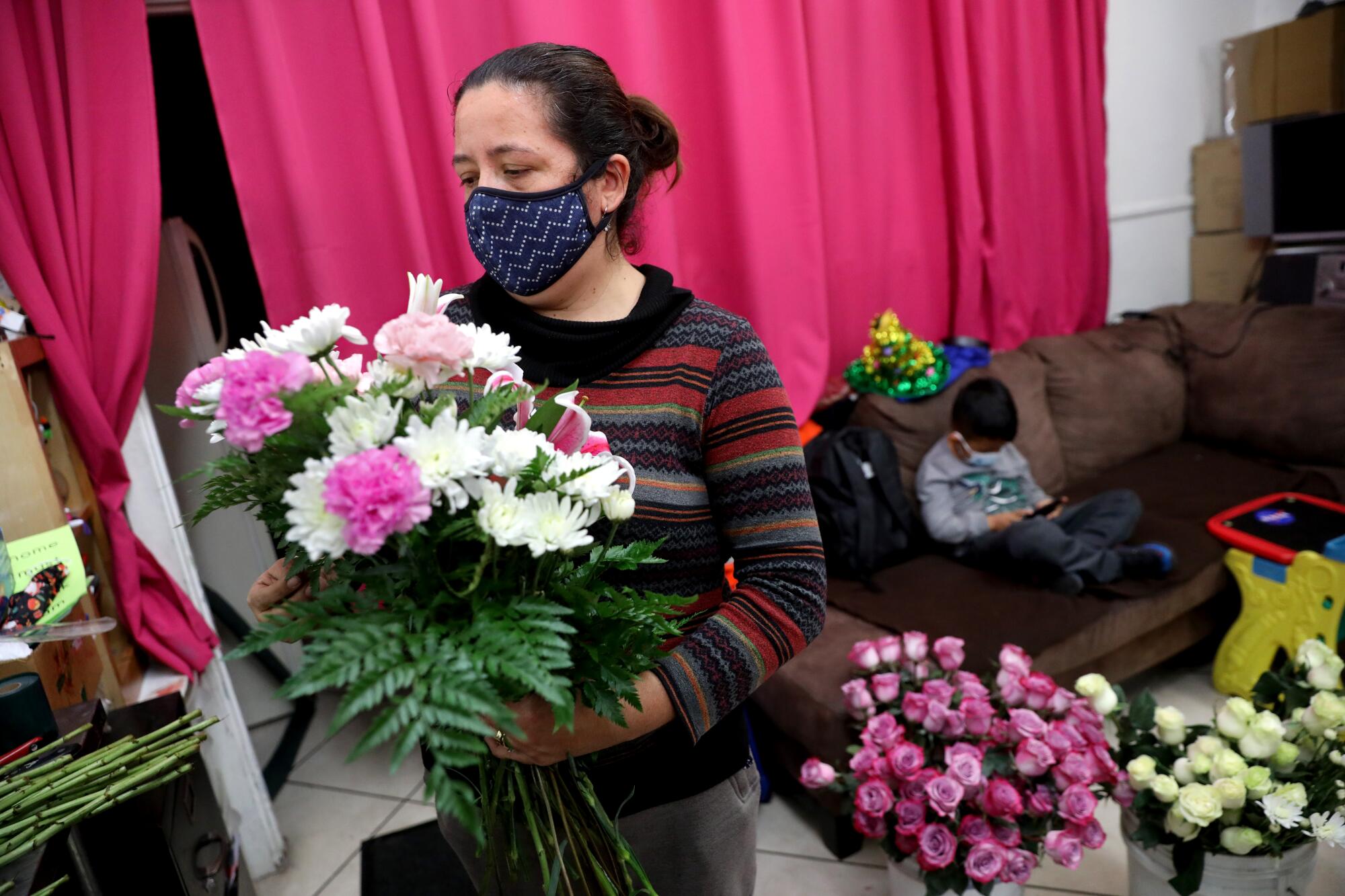 Elizabeth Garibay prepares a floral arrangement for a weekly customer at J&I Florist in East Los Angeles.
