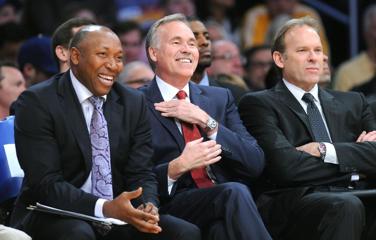 Lakers Coach Mike D'Antoni, center, and assistant Johnny Davis share a laugh next to assistant Kurt Rambis in the first half Thursday.