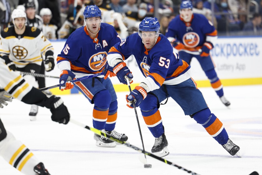 New York Islanders center Casey Cizikas (53) skates toward the goal followed by right wing Cal Clutterbuck (15) during the second period of an NHL hockey game, Thursday, Dec. 16, 2021, in Elmont, N.Y. (AP Photo/Corey Sipkin).