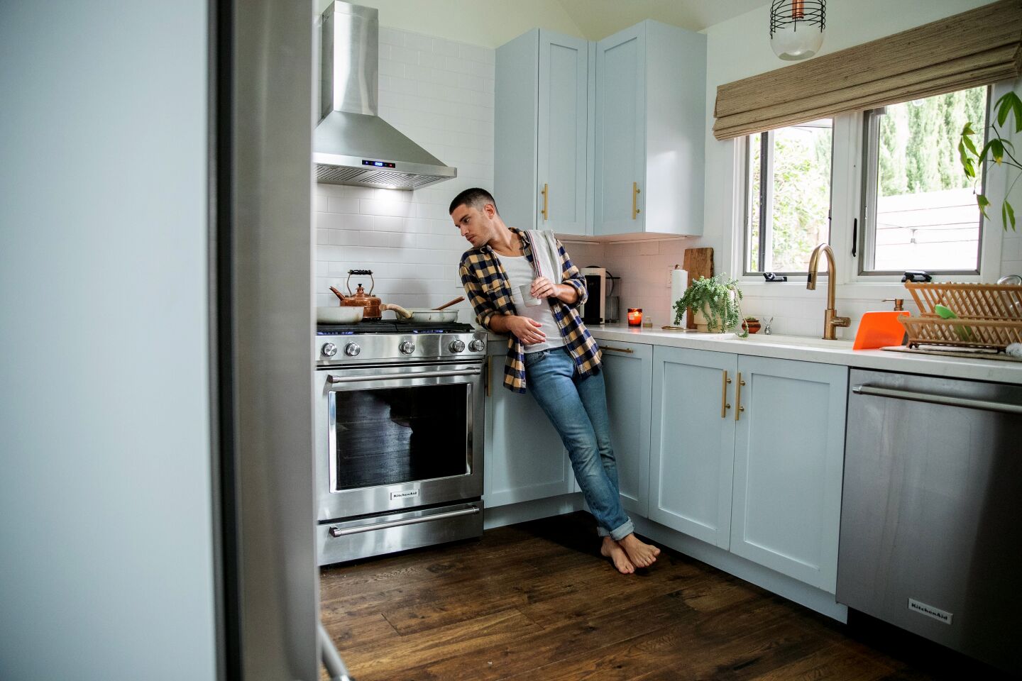 Actor Ronen Rubinstein finds that cooking in his light-filled kitchen helps him keep a positive attitude as he isolates at home. Photographed April 5, 2020. (Stephen LaMarche)