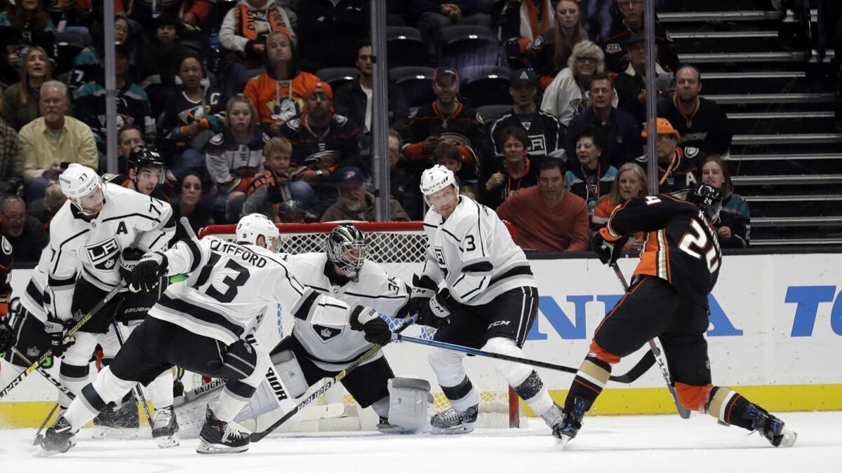 Ducks' Carter Rowney, right, shoots and scores against the Kings during the first period.