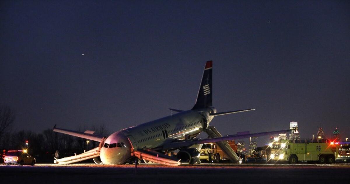 A damaged US Airways jet lies at the end of a runway at Philadelphia International Airport.