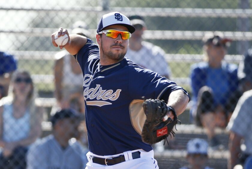Padres catcher Austin Hedges steps into a throw to second during drills prior to a spring training baseball game against the San Francisco Giants Tuesday, March 10, 2015, in Peoria, Ariz.