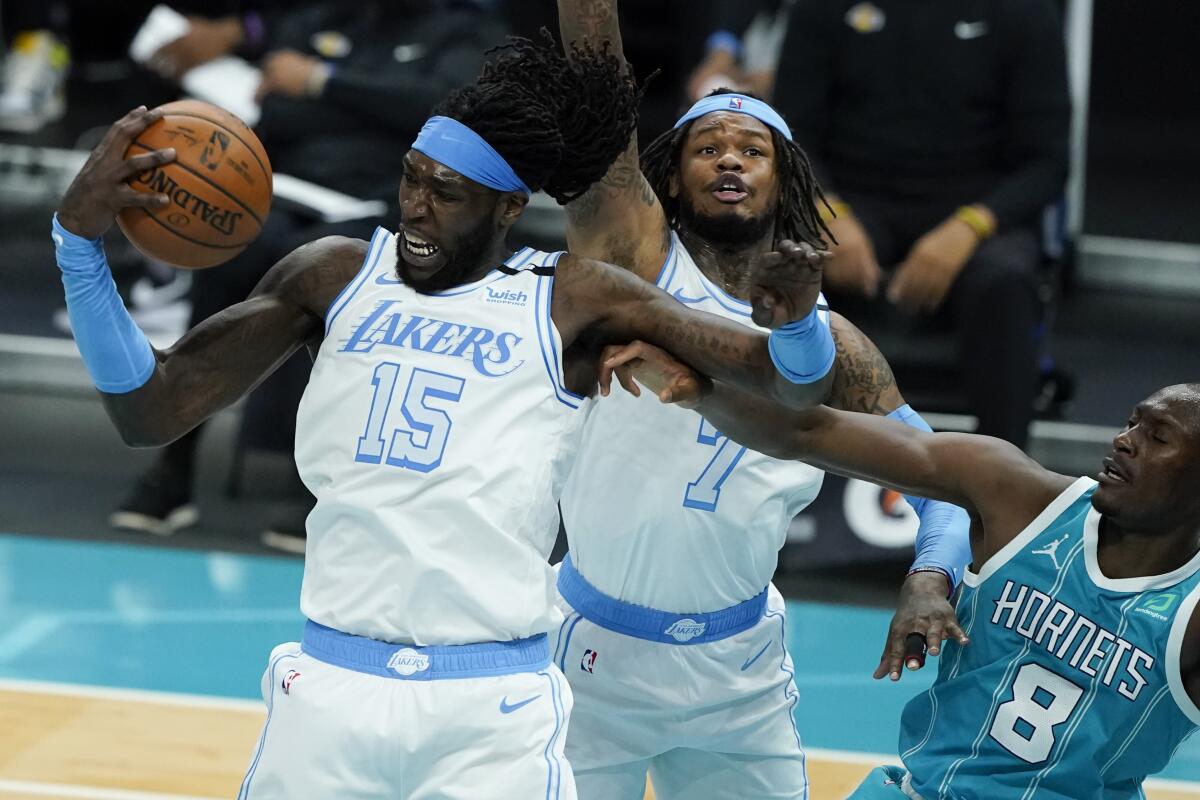 Los Angeles Lakers center Montrezl Harrell pulls a rebound away from Charlotte Hornets center Bismack Biyombo during the second half in an NBA basketball game on Tuesday, April 13, 2021, in Charlotte, N.C. (AP Photo/Chris Carlson)