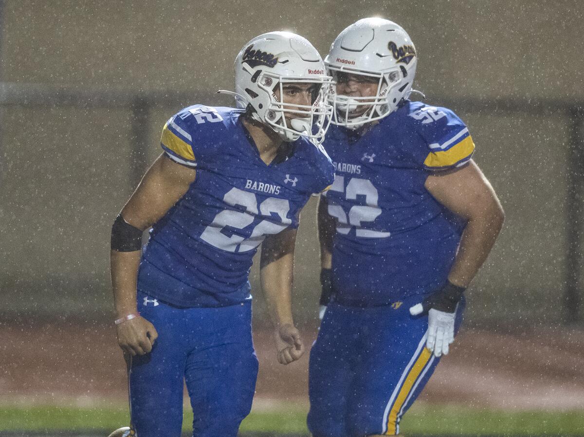 Fountain Valley's Frank Oviedo, right, celebrates with Abdel Habibeh after he scores a touchdown against Marina.