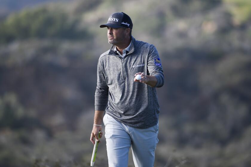 Ryan Palmer holds up the ball after hitting a birdie putt on the 17th hole of the North Course at Torrey Pines Golf Course during the second round of the Farmers Insurance golf tournament Friday, Jan. 24, 2020, in San Diego. (AP Photo/Denis Poroy)