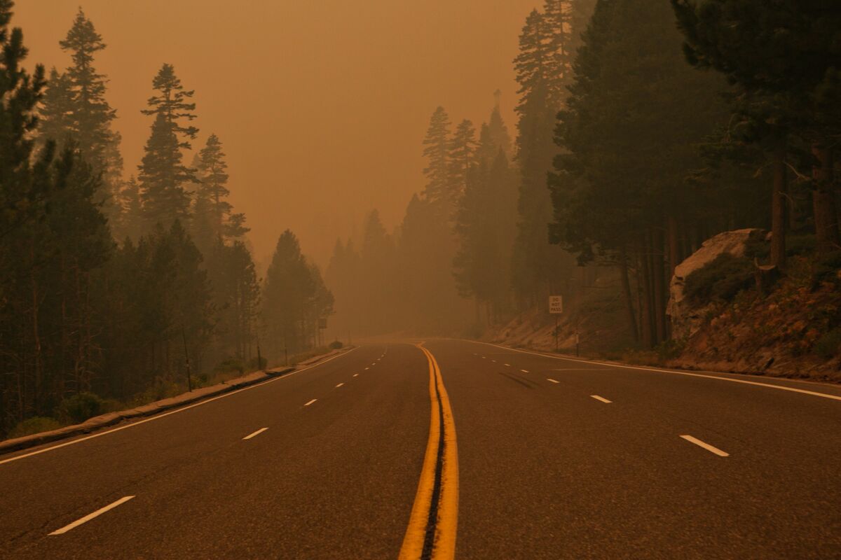 Smoke and ash hang over Highway 50